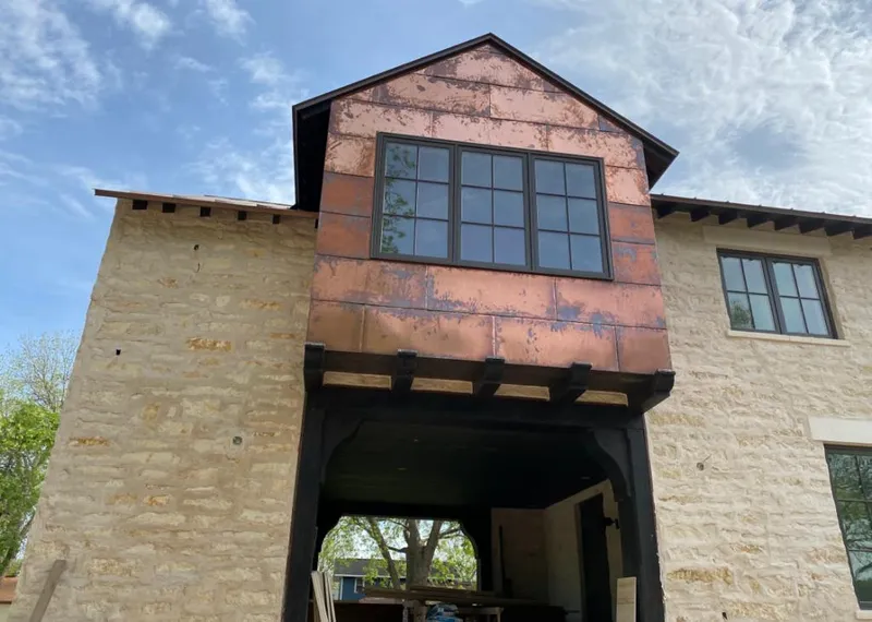 Copper metal panel facade on a stone building for Skylight Installation in El Dorado